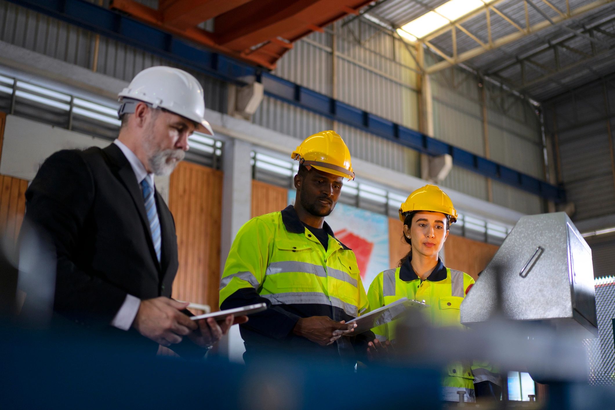Engineer reviewing plans in factory environment