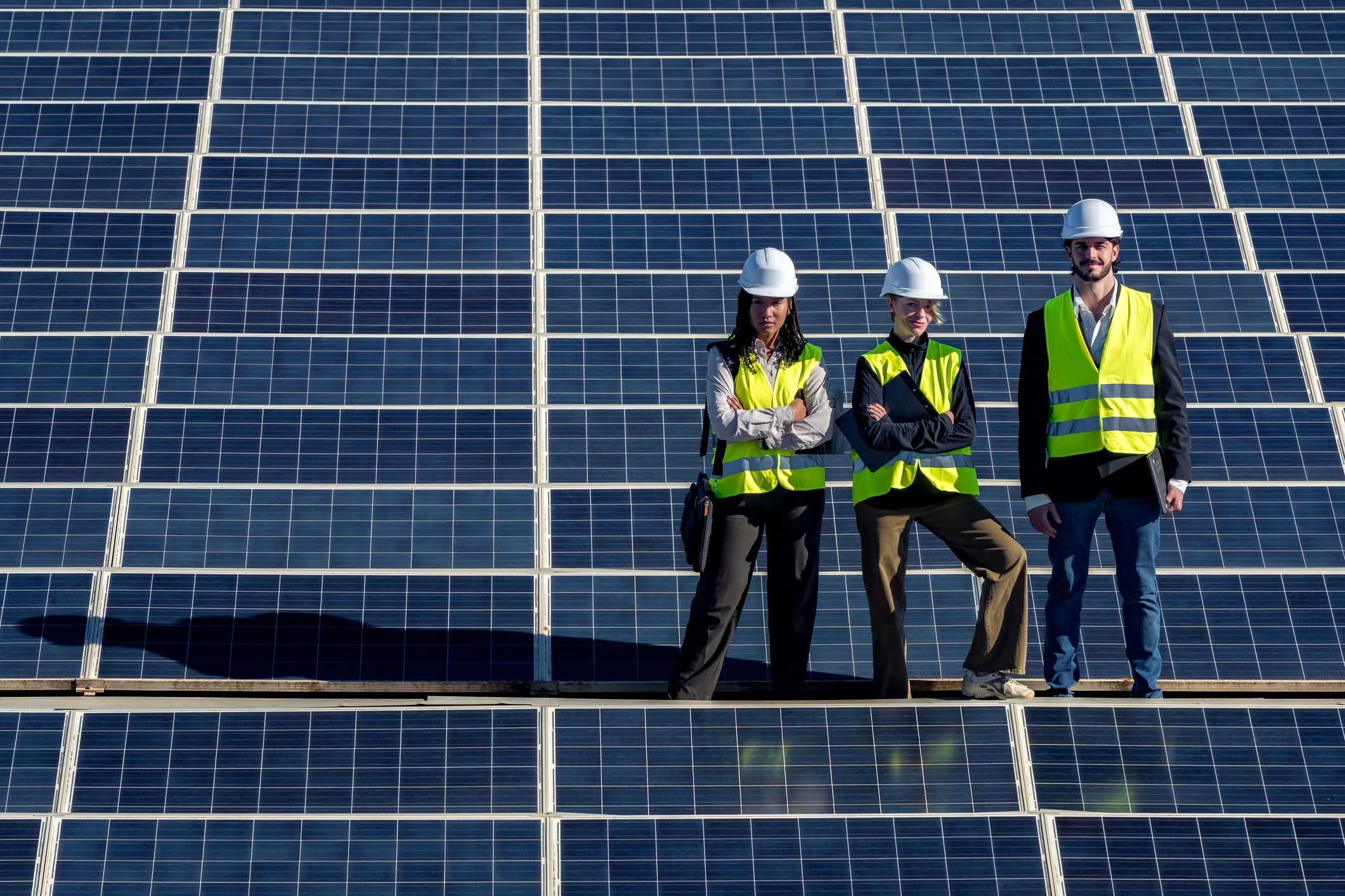 Engineers standing on solar panels